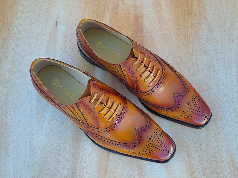 a pair of cognac brown color men shoes