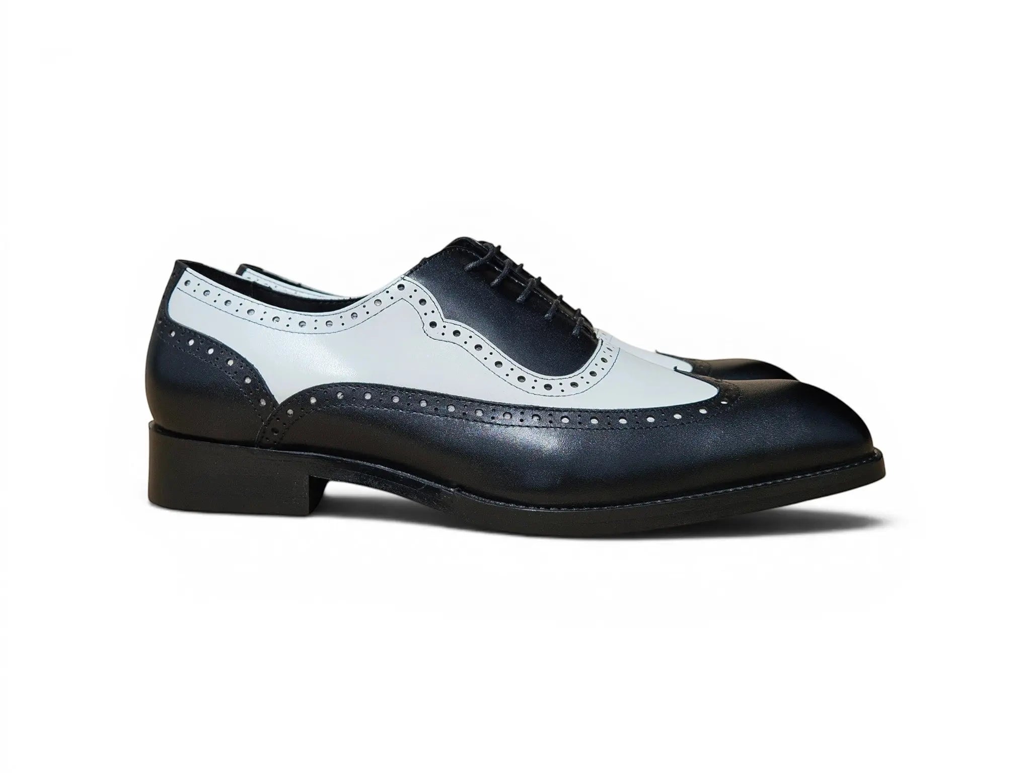Carrucci Shoes Alex two-tone black and white leather wingtip oxford with brogue perforations and lace-up closure.